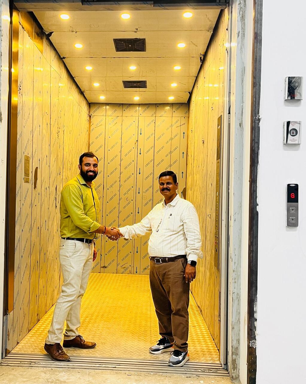 Team handing over a newly installed elevator in a commercial building in Noida